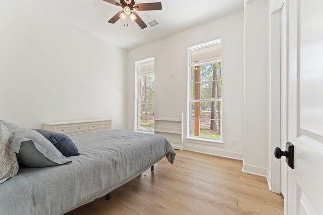 567 Lonestar Rd, Huntsville, TX 77340 - bedroom featuring light wood-style floors, ceiling fan, and baseboards