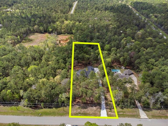567 Lonestar Rd, Huntsville, TX 77340 - aerial view of property and surrounding area with a heavily wooded area and property boundaries highlighted