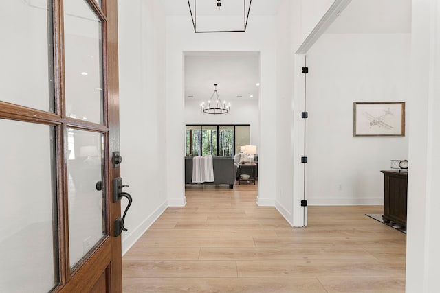 567 Lonestar Rd, Huntsville, TX 77340 - entryway featuring a chandelier, light wood finished floors, and baseboards