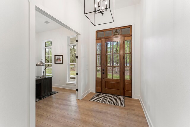 567 Lonestar Rd, Huntsville, TX 77340 - entrance foyer featuring light wood-style flooring, baseboards, and a chandelier