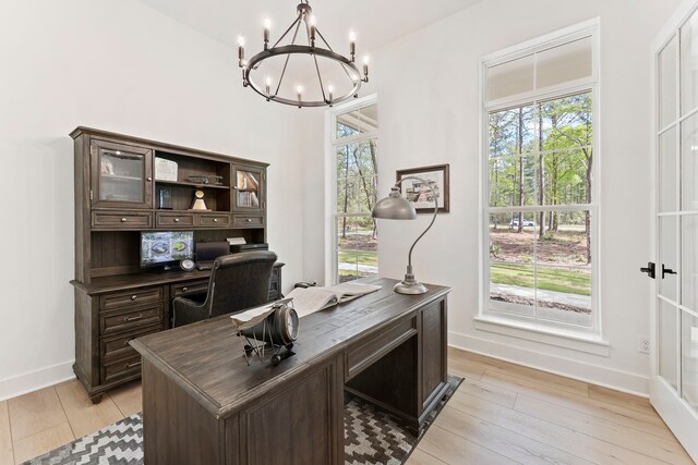 567 Lonestar Rd, Huntsville, TX 77340 - office area with a chandelier, baseboards, and light wood-style floors