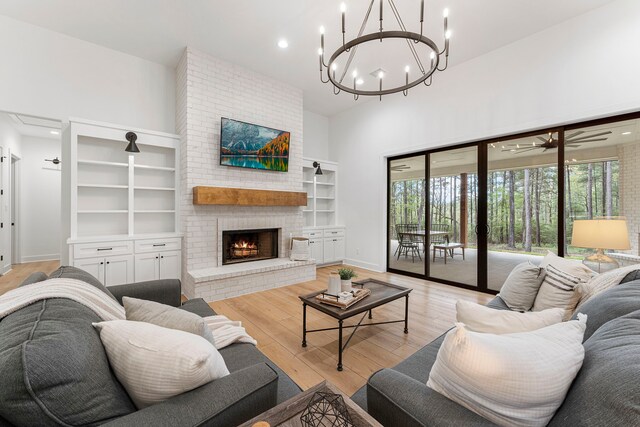 567 Lonestar Rd, Huntsville, TX 77340 - living room featuring a high ceiling, light wood finished floors, a fireplace, recessed lighting, and a chandelier