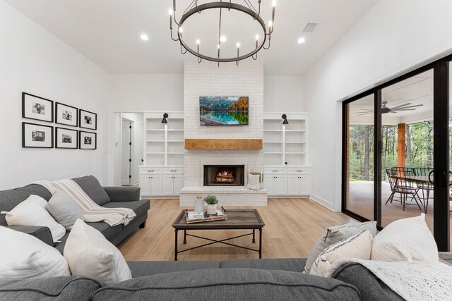 567 Lonestar Rd, Huntsville, TX 77340 - living area with a chandelier, a brick fireplace, light wood finished floors, and recessed lighting