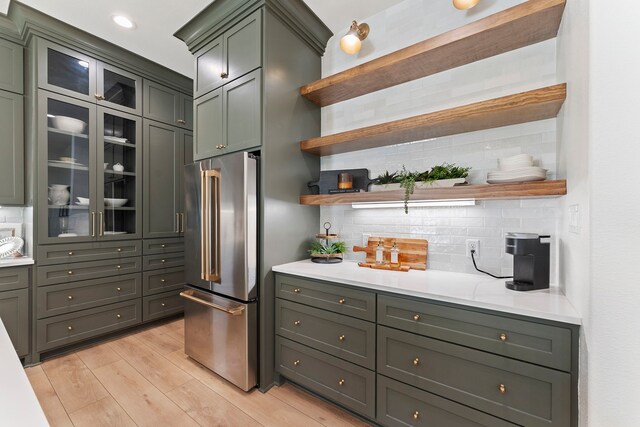 567 Lonestar Rd, Huntsville, TX 77340 - kitchen with high end fridge, open shelves, light countertops, and backsplash