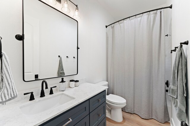 567 Lonestar Rd, Huntsville, TX 77340 - full bathroom with vanity, toilet, and wood finished floors