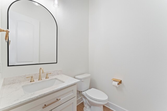 567 Lonestar Rd, Huntsville, TX 77340 - half bathroom with baseboards, vanity, and toilet