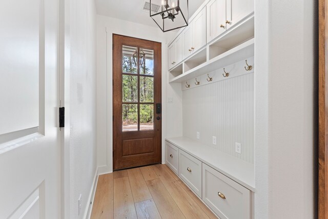 567 Lonestar Rd, Huntsville, TX 77340 - mudroom featuring a chandelier, light wood-style flooring, and baseboards
