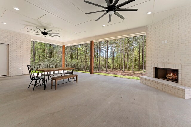 567 Lonestar Rd, Huntsville, TX 77340 - view of patio featuring ceiling fan, outdoor dining space, and an outdoor brick fireplace