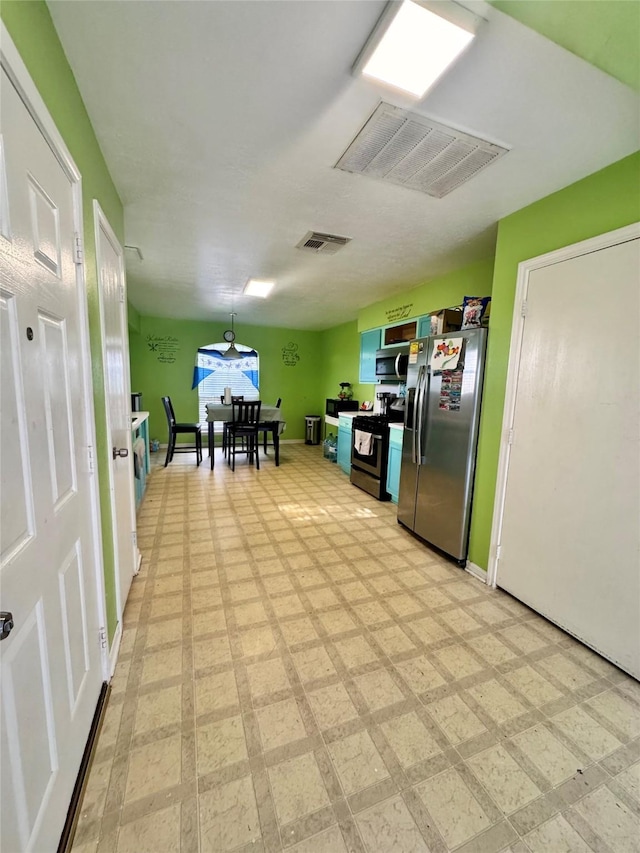 4631 Mi Castillo Ct, Houston, TX 77045 - kitchen with stainless steel appliances, light floors, and baseboards