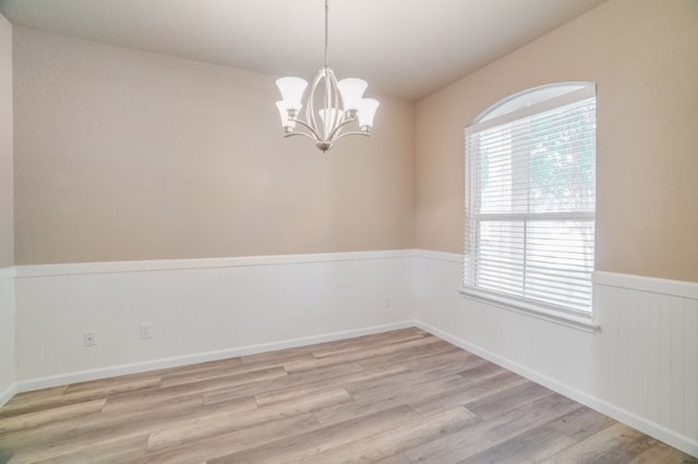 6763 Indian Ldg, San Antonio, TX 78253 - unfurnished room featuring a wainscoted wall, wood finished floors, and a chandelier