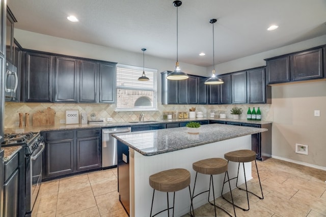 6763 Indian Ldg, San Antonio, TX 78253 - kitchen with stainless steel appliances, a sink, stone counters, decorative backsplash, and a kitchen island