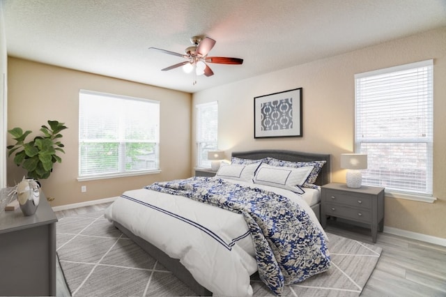 6763 Indian Ldg, San Antonio, TX 78253 - bedroom featuring baseboards, wood finished floors, a ceiling fan, and a textured ceiling