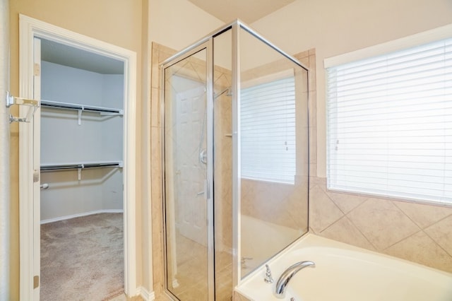 6763 Indian Ldg, San Antonio, TX 78253 - full bath featuring a stall shower, a walk in closet, a garden tub, and healthy amount of natural light