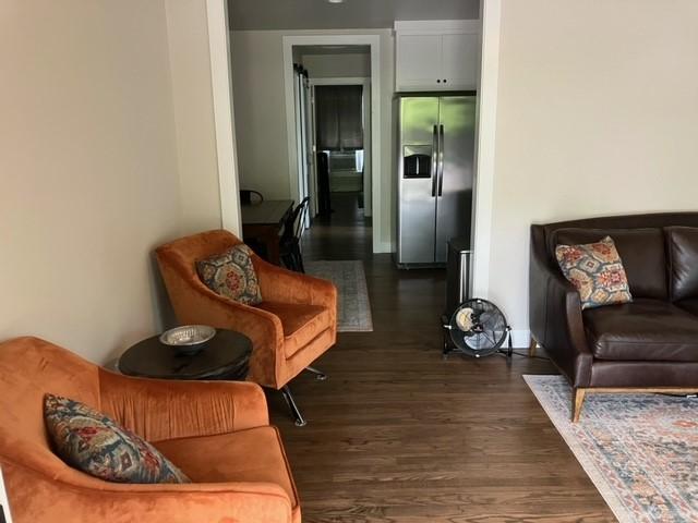 204 E Dry St, San Saba, TX 76877 - living area featuring dark wood-type flooring