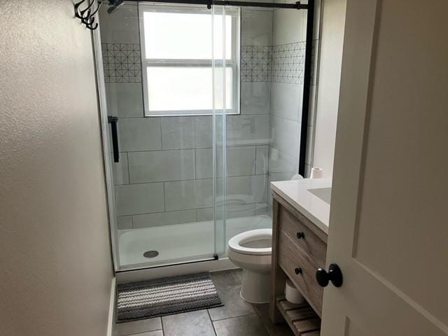 204 E Dry St, San Saba, TX 76877 - full bath with toilet, a shower stall, vanity, tile patterned flooring, and a textured wall