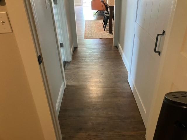 204 E Dry St, San Saba, TX 76877 - hall with dark wood-type flooring and baseboards