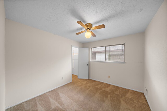 1639 Castle Creek Dr, Missouri City, TX 77489 - unfurnished bedroom with carpet flooring, a walk in closet, baseboards, a closet, and ceiling fan