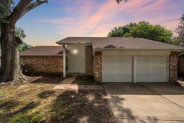 1639 Castle Creek Dr, Missouri City, TX 77489 - view of front of house featuring brick siding, a garage, driveway, and roof with shingles