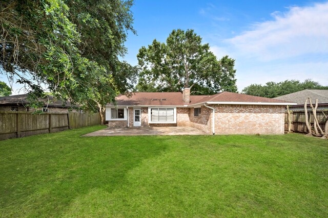 1639 Castle Creek Dr, Missouri City, TX 77489 - back of house featuring a patio, brick siding, and a chimney