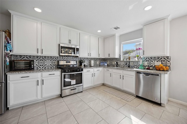 10123 Twila Springs Ct, Houston, TX 77095 - kitchen with appliances with stainless steel finishes, a sink, tasteful backsplash, white cabinetry, and recessed lighting
