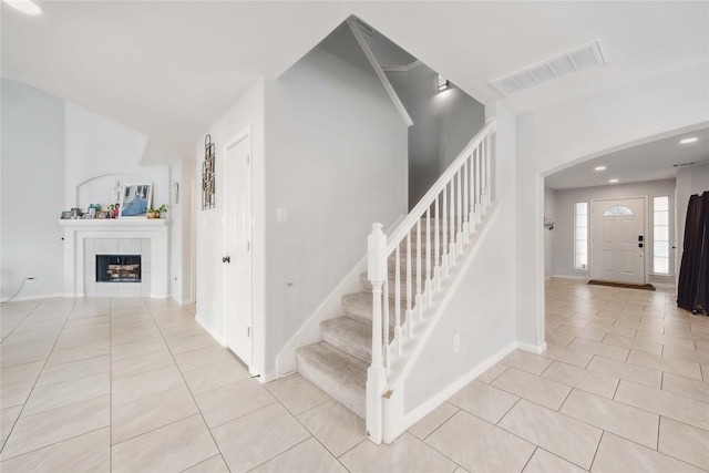 10123 Twila Springs Ct, Houston, TX 77095 - entrance foyer with light tile patterned floors, stairs, baseboards, and a fireplace