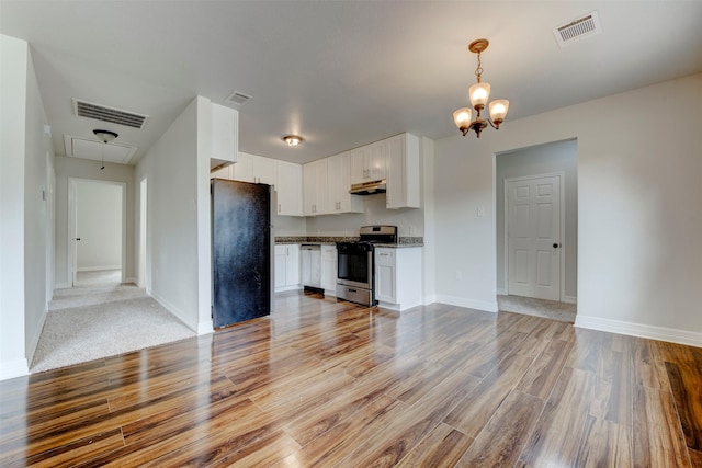9022 Sultan Dr, Houston, TX 77078 - kitchen featuring appliances with stainless steel finishes, under cabinet range hood, light wood-style floors, white cabinetry, and a chandelier