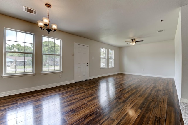 9022 Sultan Dr, Houston, TX 77078 - empty room featuring a chandelier, a ceiling fan, dark wood-type flooring, and baseboards