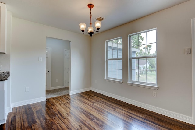 9022 Sultan Dr, Houston, TX 77078 - unfurnished dining area featuring dark wood-style floors, a chandelier, and baseboards