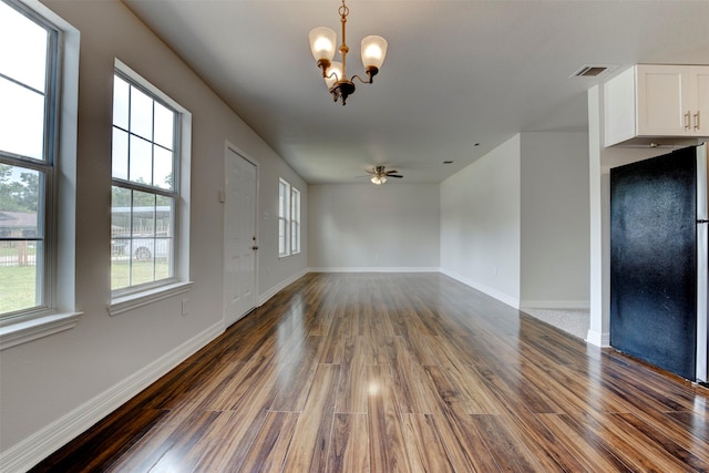 9022 Sultan Dr, Houston, TX 77078 - unfurnished room with dark wood-type flooring, a chandelier, healthy amount of natural light, and baseboards