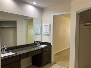 2214 S Ferrisburg Ct, Sugar Land, TX 77478 - bathroom featuring tile patterned floors, double vanity, recessed lighting, and baseboards
