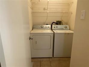 2214 S Ferrisburg Ct, Sugar Land, TX 77478 - laundry room featuring independent washer and dryer and tile patterned flooring