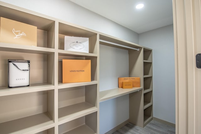 103 Whispering Oaks, Somerville, TX 77879 - walk in closet featuring wood finished floors