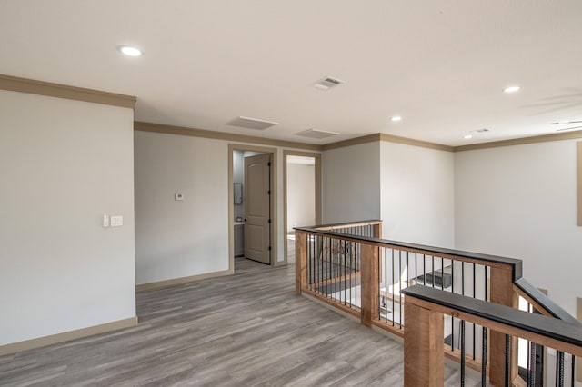 103 Whispering Oaks, Somerville, TX 77879 - corridor featuring an upstairs landing, ornamental molding, wood finished floors, recessed lighting, and baseboards