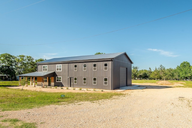 103 Whispering Oaks, Somerville, TX 77879 - view of front facade with driveway, an outdoor structure, and metal roof