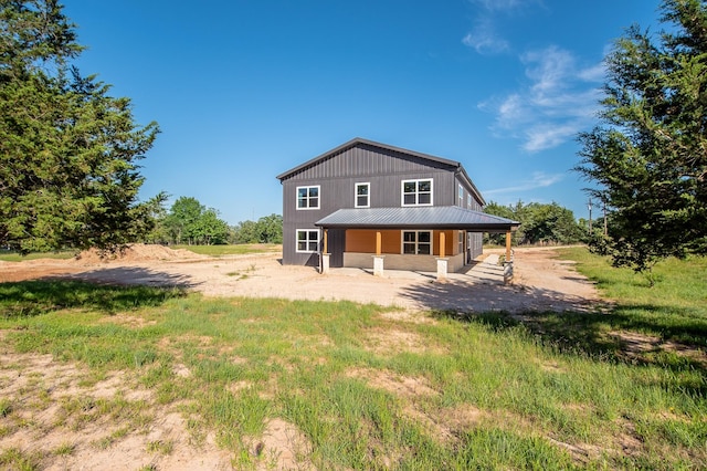103 Whispering Oaks, Somerville, TX 77879 - rear view of house featuring a porch and metal roof