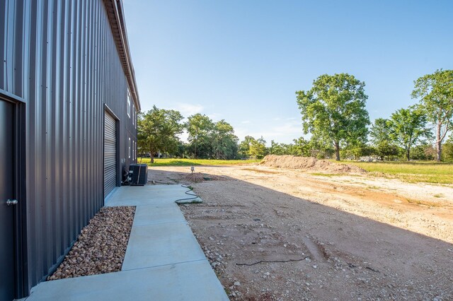 103 Whispering Oaks, Somerville, TX 77879 - view of yard with a garage and central AC unit