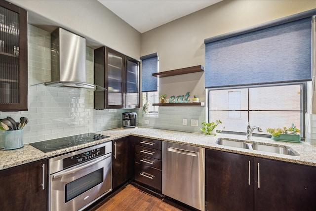 2110 Shearn St Unit 5, Houston, TX 77007 - kitchen featuring appliances with stainless steel finishes, wall chimney exhaust hood, a sink, dark brown cabinetry, and dark wood finished floors