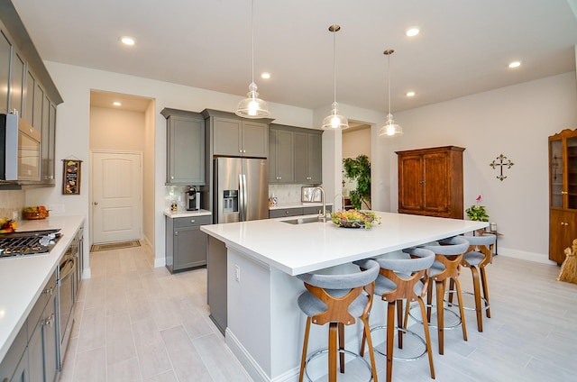 18234 Shoreline Vista Ln, Cypress, TX 77433 - kitchen featuring stainless steel appliances, a sink, gray cabinetry, baseboards, and recessed lighting