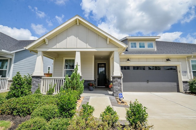 18234 Shoreline Vista Ln, Cypress, TX 77433 - craftsman house featuring board and batten siding, driveway, stone siding, a shingled roof, and a porch