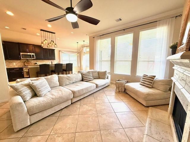 1216 Matthew Hills Ln, Spring, TX 77386 - living room with a fireplace, light tile patterned floors, a ceiling fan, and recessed lighting