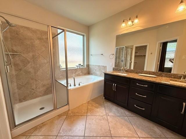 1216 Matthew Hills Ln, Spring, TX 77386 - full bath featuring a bath, double vanity, a shower stall, tile patterned flooring, and healthy amount of natural light