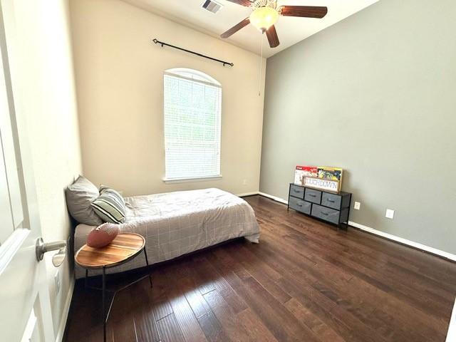 1216 Matthew Hills Ln, Spring, TX 77386 - bedroom with hardwood / wood-style floors, baseboards, and ceiling fan