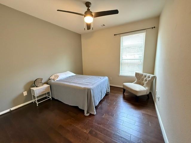 1216 Matthew Hills Ln, Spring, TX 77386 - bedroom featuring baseboards, dark wood-style floors, and a ceiling fan