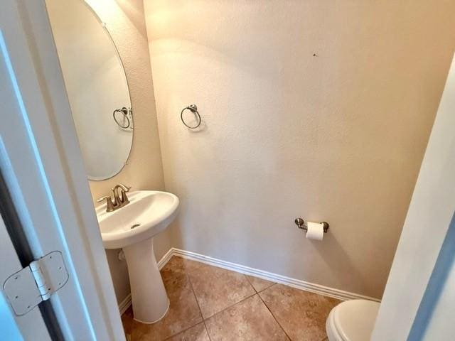 1216 Matthew Hills Ln, Spring, TX 77386 - bathroom with toilet, tile patterned flooring, and baseboards