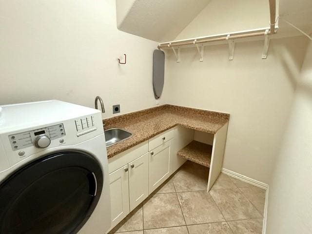 1216 Matthew Hills Ln, Spring, TX 77386 - washroom with washer / clothes dryer, cabinet space, light tile patterned floors, and baseboards