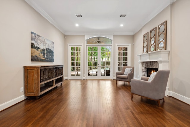 12126 Oak Park Dr, Houston, TX 77070 - living area with a lit fireplace, dark wood-style flooring, recessed lighting, crown molding, and baseboards