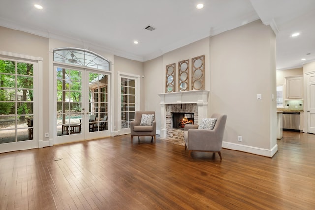 12126 Oak Park Dr, Houston, TX 77070 - living area featuring a brick fireplace, hardwood / wood-style floors, crown molding, recessed lighting, and baseboards