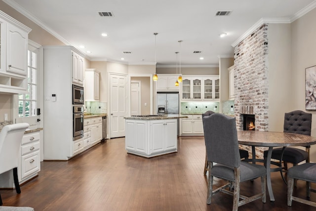 12126 Oak Park Dr, Houston, TX 77070 - dining space with a brick fireplace, dark wood-style flooring, recessed lighting, and ornamental molding