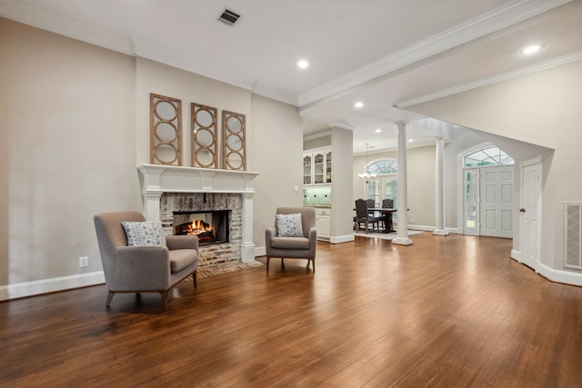 12126 Oak Park Dr, Houston, TX 77070 - sitting room featuring a multi sided fireplace, wood-type flooring, ornate columns, baseboards, and ornamental molding
