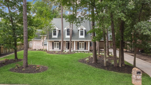 12126 Oak Park Dr, Houston, TX 77070 - cape cod house featuring french doors, concrete driveway, and brick siding